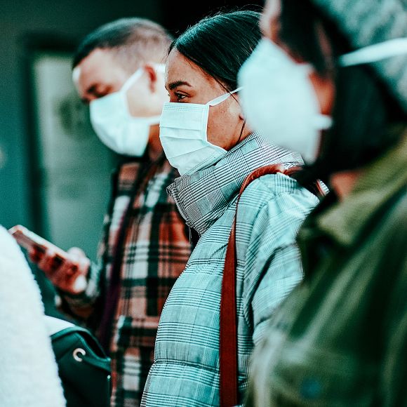 Group of masked people walking together outdoors