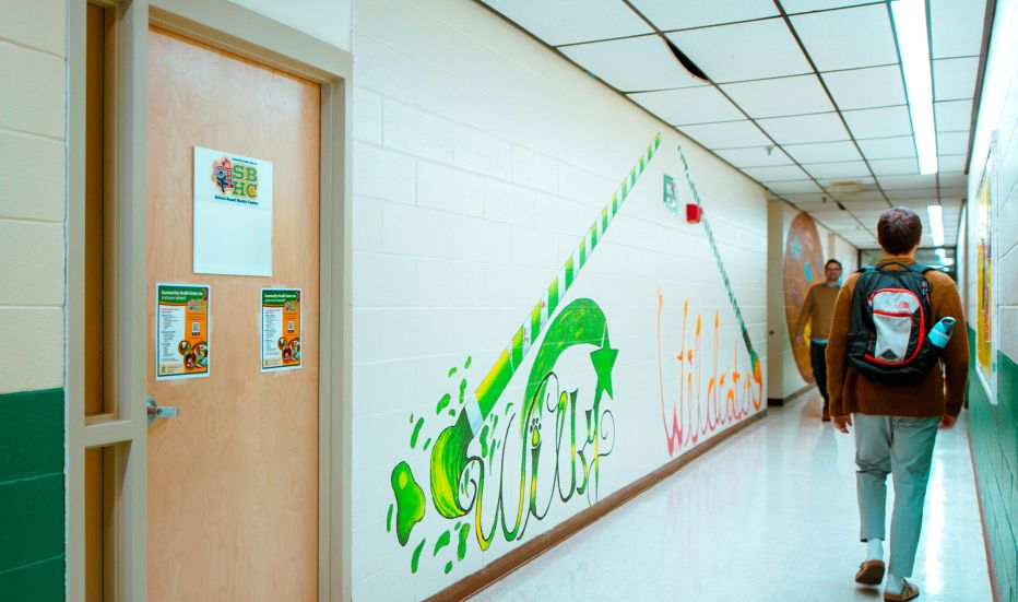 Student walking through school hallway